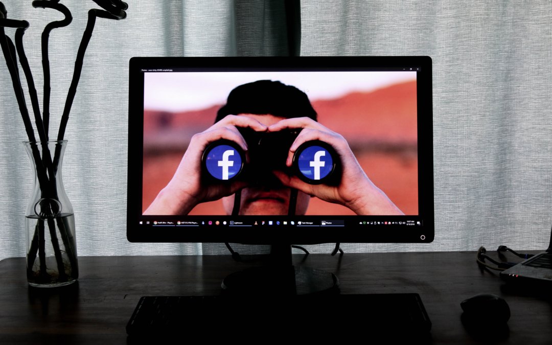 photos on a computer monitor of a man with binoculars with the Facebook logo on them